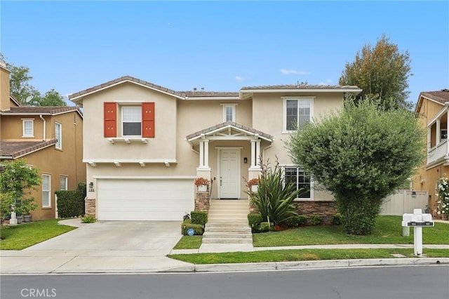 103 Corte Tierra Bella, San Clemente, CA 92673 - view of front of home featuring concrete driveway, an attached garage, stucco siding, stone siding, and a front lawn