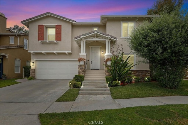 103 Corte Tierra Bella, San Clemente, CA 92673 - view of front facade featuring stucco siding, an attached garage, concrete driveway, stone siding, and a front yard