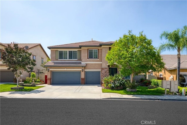30185 Tenaya Ln, Highland, CA 92346 - view of front of house with stucco siding, an attached garage, concrete driveway, and a tiled roof