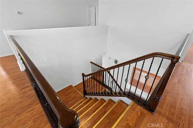 30185 Tenaya Ln, Highland, CA 92346 - stairway with wood finished floors and baseboards