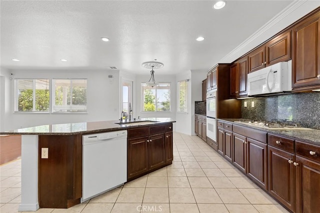 30185 Tenaya Ln, Highland, CA 92346 - kitchen with white appliances, a sink, a kitchen island with sink, recessed lighting, and backsplash
