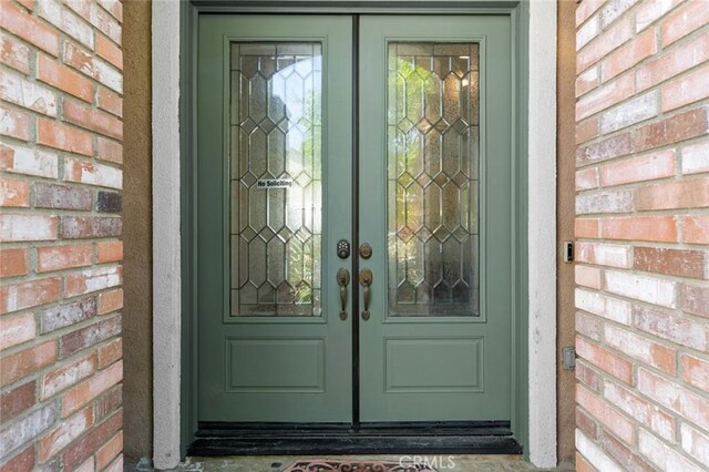 30185 Tenaya Ln, Highland, CA 92346 - view of exterior entry featuring french doors and brick siding