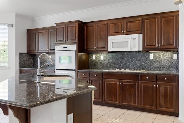 30185 Tenaya Ln, Highland, CA 92346 - kitchen featuring white appliances, dark stone countertops, light tile patterned flooring, a sink, and crown molding
