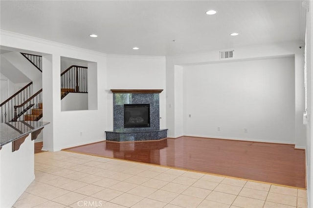 30185 Tenaya Ln, Highland, CA 92346 - unfurnished living room with light tile patterned floors, stairway, recessed lighting, a fireplace, and crown molding