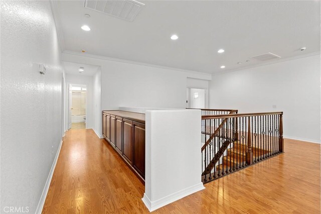 30185 Tenaya Ln, Highland, CA 92346 - corridor with an upstairs landing, light wood finished floors, ornamental molding, recessed lighting, and baseboards