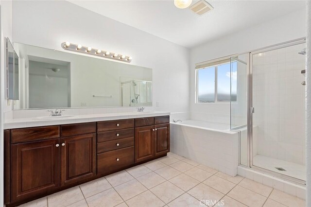 30185 Tenaya Ln, Highland, CA 92346 - bathroom featuring double vanity, a garden tub, a stall shower, and tile patterned floors