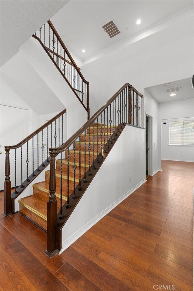 30185 Tenaya Ln, Highland, CA 92346 - stairway with wood-type flooring, baseboards, and recessed lighting