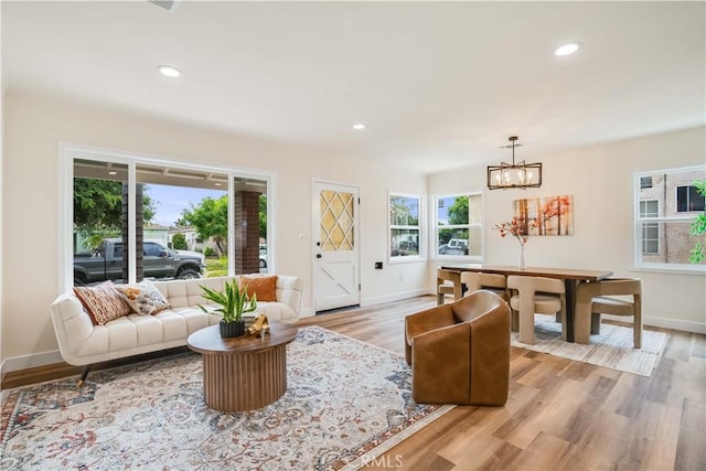 9331 Hunt Ave, South Gate, CA 90280 - living room featuring baseboards, a chandelier, light wood finished floors, and recessed lighting
