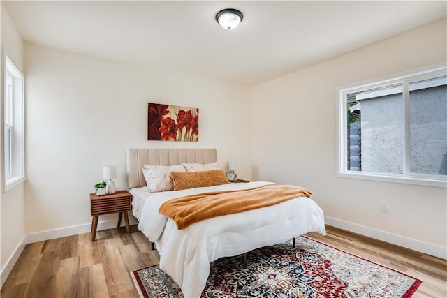 9331 Hunt Ave, South Gate, CA 90280 - bedroom with light wood-type flooring and baseboards
