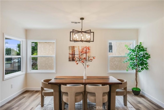9331 Hunt Ave, South Gate, CA 90280 - dining area featuring baseboards, a chandelier, and light wood-type flooring