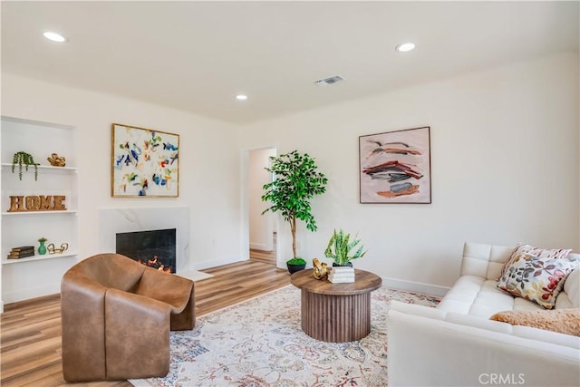9331 Hunt Ave, South Gate, CA 90280 - living area with wood finished floors, a high end fireplace, recessed lighting, and baseboards