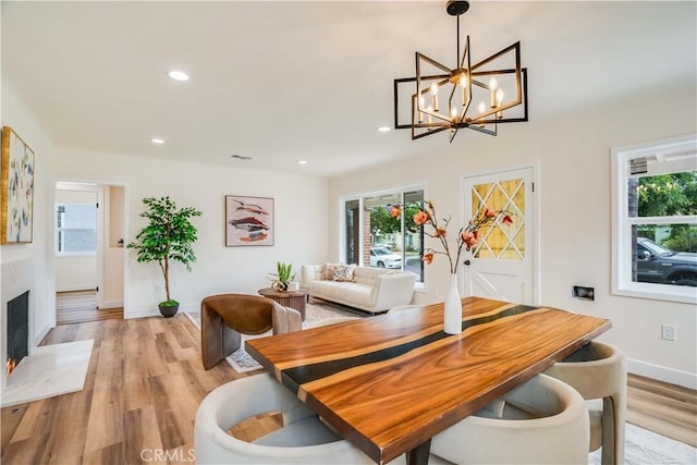 9331 Hunt Ave, South Gate, CA 90280 - dining space featuring baseboards, light wood-style flooring, recessed lighting, a chandelier, and a high end fireplace