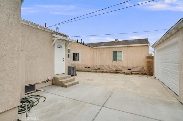 9331 Hunt Ave, South Gate, CA 90280 - view of patio featuring a garage, entry steps, and central air condition unit