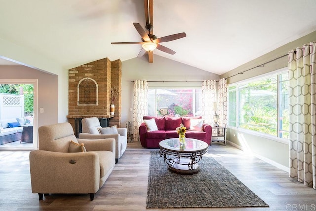 1302 El Corral Ln, San Marcos, CA 92078 - living room with healthy amount of natural light, wood finished floors, ceiling fan, and a brick fireplace