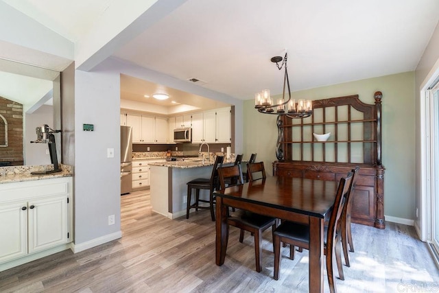 1302 El Corral Ln, San Marcos, CA 92078 - dining area with a chandelier and light wood-type flooring