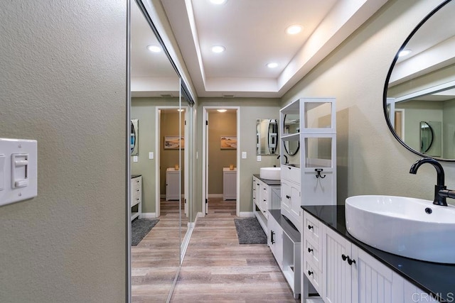 1302 El Corral Ln, San Marcos, CA 92078 - full bath featuring double vanity, wood finished floors, recessed lighting, a raised ceiling, and a textured wall