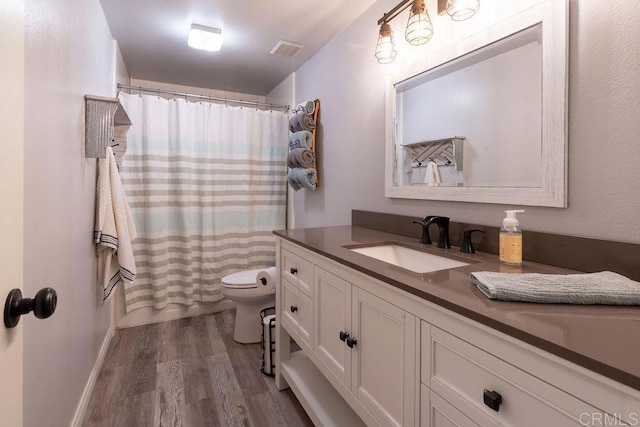 1302 El Corral Ln, San Marcos, CA 92078 - bathroom with wood finished floors, vanity, and a shower with shower curtain