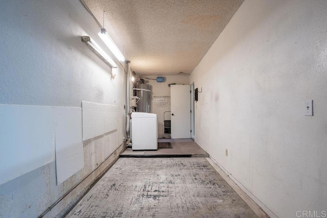 1302 El Corral Ln, San Marcos, CA 92078 - hall featuring strapped water heater, a textured ceiling, and washer / dryer