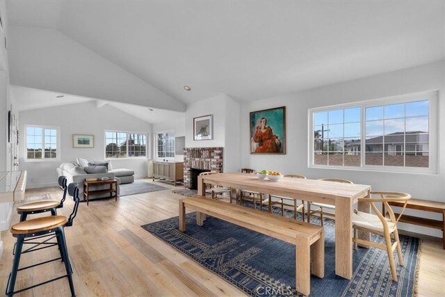 320 W 19th St Unit 1, San Pedro, CA 90731 - dining room with wood finished floors, lofted ceiling, and a brick fireplace