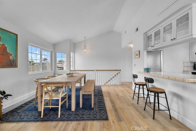 320 W 19th St Unit 1, San Pedro, CA 90731 - dining room with light wood-style floors, baseboards, and high vaulted ceiling