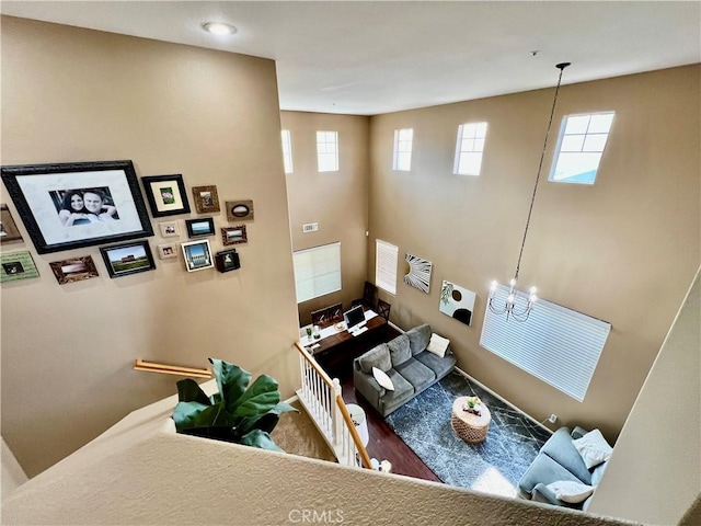 5890 Kendrick Dr, Riverside, CA 92507 - living area with a towering ceiling, a chandelier, and baseboards