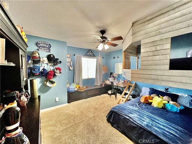 5890 Kendrick Dr, Riverside, CA 92507 - carpeted bedroom featuring wooden walls, a textured ceiling, ceiling fan, and baseboards
