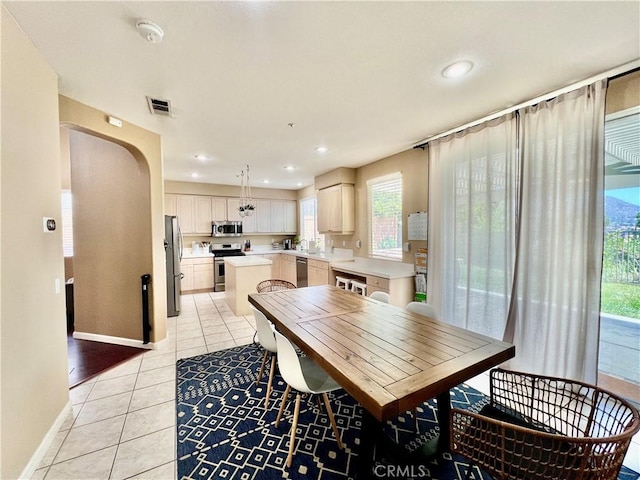 5890 Kendrick Dr, Riverside, CA 92507 - dining room featuring light tile patterned floors, baseboards, arched walkways, and recessed lighting