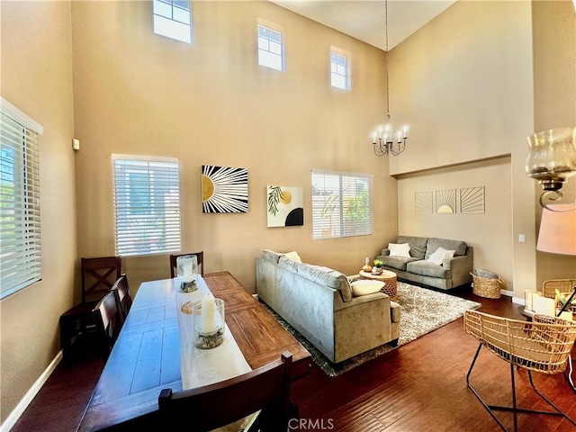 5890 Kendrick Dr, Riverside, CA 92507 - living area featuring a towering ceiling, healthy amount of natural light, wood finished floors, a chandelier, and baseboards