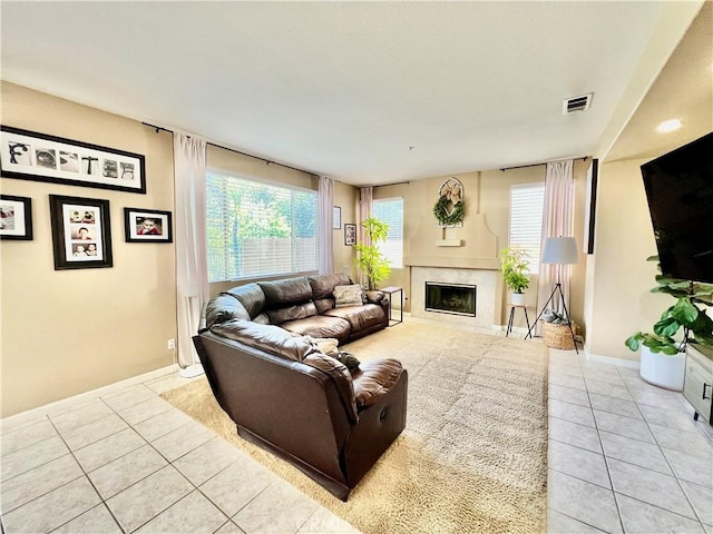 5890 Kendrick Dr, Riverside, CA 92507 - living room featuring light tile patterned floors, healthy amount of natural light, a high end fireplace, and baseboards