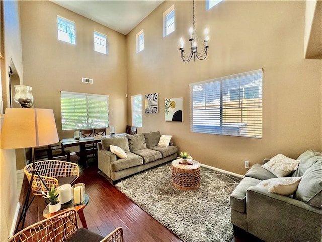 5890 Kendrick Dr, Riverside, CA 92507 - living room featuring dark wood finished floors, a chandelier, and a towering ceiling