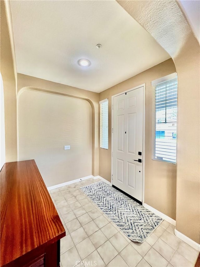 5890 Kendrick Dr, Riverside, CA 92507 - entrance foyer with arched walkways, light tile patterned floors, and baseboards