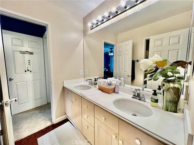 5890 Kendrick Dr, Riverside, CA 92507 - full bathroom with double vanity, wood finished floors, and baseboards