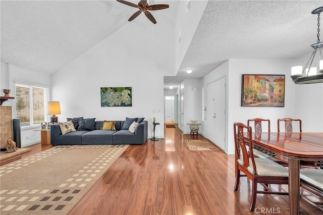 20043 Emerald Meadow Dr, Walnut, CA 91789 - living room with wood finished floors, ceiling fan, a textured ceiling, and high vaulted ceiling