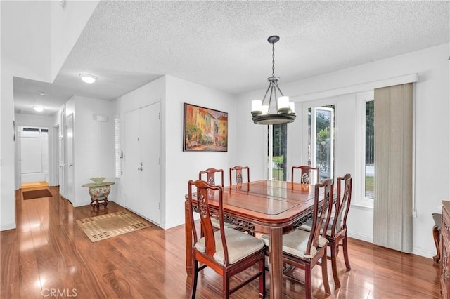 20043 Emerald Meadow Dr, Walnut, CA 91789 - dining area with a textured ceiling, wood finished floors, baseboards, and a chandelier