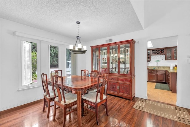 20043 Emerald Meadow Dr, Walnut, CA 91789 - dining area with a textured ceiling, wet bar, light wood-style floors, and baseboards