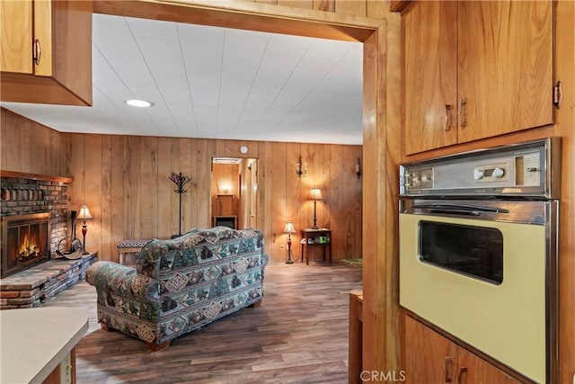 943 Meadowbrook Rd, Lake Arrowhead, CA 92352 - living room with a brick fireplace, dark wood finished floors, wooden walls, and recessed lighting