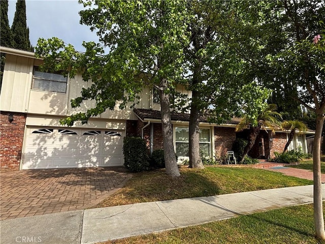 1512 Camino Lindo, South Pasadena, CA 91030 - view of front facade with brick siding, an attached garage, decorative driveway, and a front yard