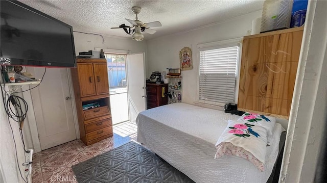 8933 Bowman Ave, South Gate, CA 90280 - bedroom featuring a textured ceiling, tile patterned floors, and ceiling fan