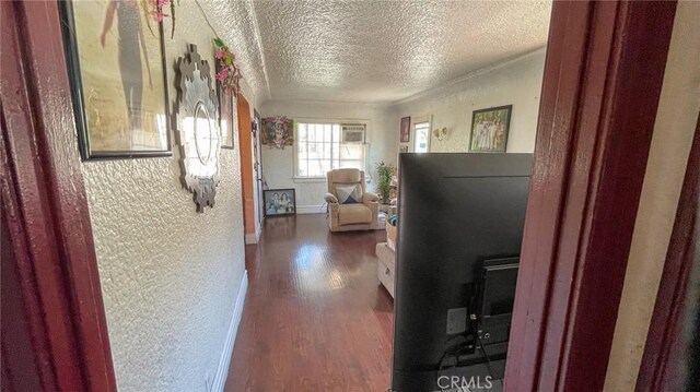 8933 Bowman Ave, South Gate, CA 90280 - hallway featuring dark wood-style floors, a textured ceiling, a textured wall, and baseboards