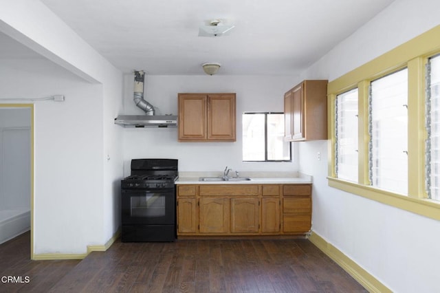 4214 Griffin Ave, Los Angeles, CA 90031 - kitchen with black gas stove, a sink, under cabinet range hood, light countertops, and dark wood-style flooring