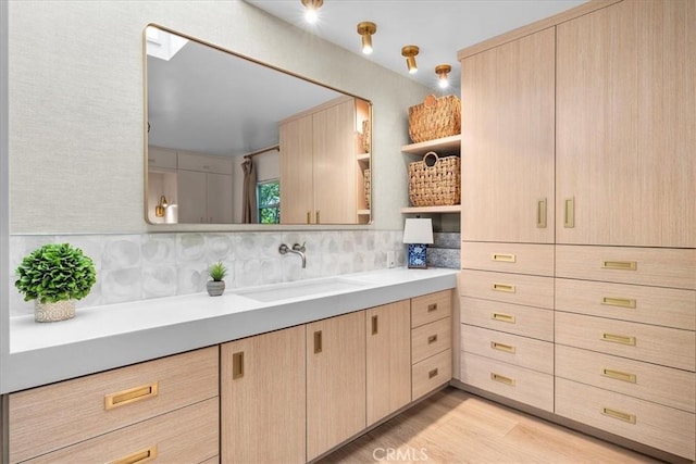 541 1st St, Manhattan Beach, CA 90266 - bathroom featuring wood finished floors, tasteful backsplash, and vanity