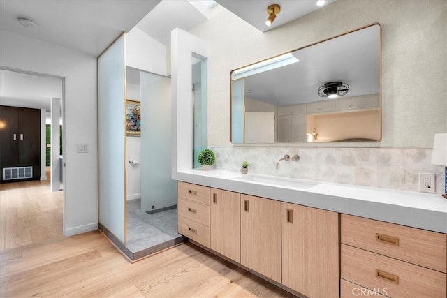 541 1st St, Manhattan Beach, CA 90266 - bathroom featuring wood finished floors, tasteful backsplash, and vanity