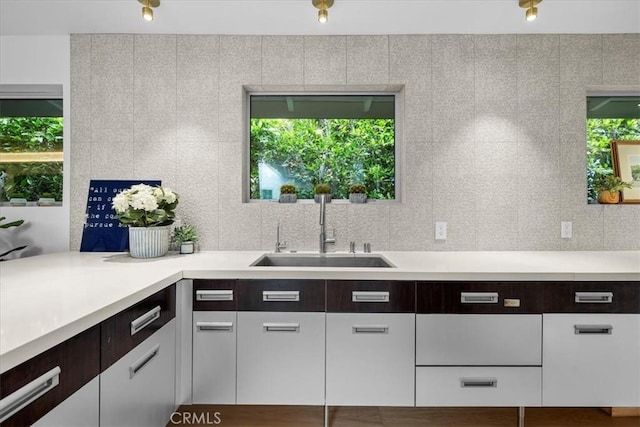 541 1st St, Manhattan Beach, CA 90266 - kitchen featuring a sink, light countertops, plenty of natural light, and white cabinetry
