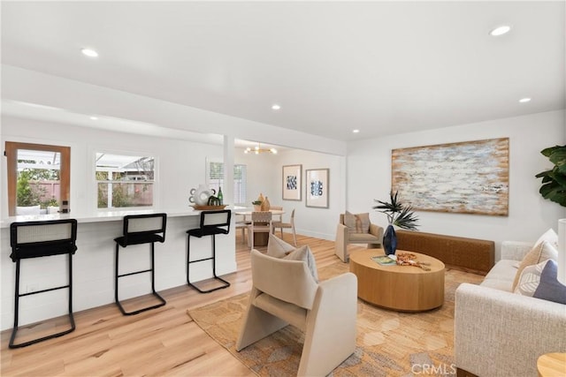 3145 Sicily Ave, Costa Mesa, CA 92626 - living room with recessed lighting, light wood-style flooring, and a chandelier