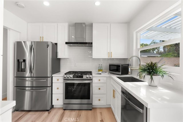 3145 Sicily Ave, Costa Mesa, CA 92626 - kitchen featuring appliances with stainless steel finishes, wall chimney range hood, a sink, light countertops, and recessed lighting