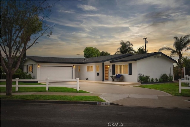 3145 Sicily Ave, Costa Mesa, CA 92626 - view of front of property featuring concrete driveway, a garage, and stucco siding