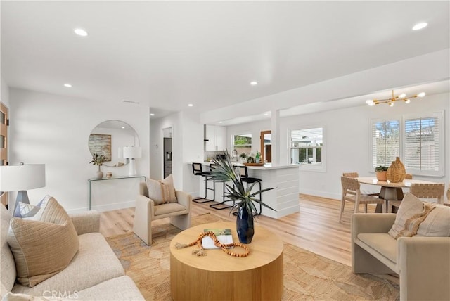 3145 Sicily Ave, Costa Mesa, CA 92626 - living area featuring recessed lighting, baseboards, light wood finished floors, and a chandelier