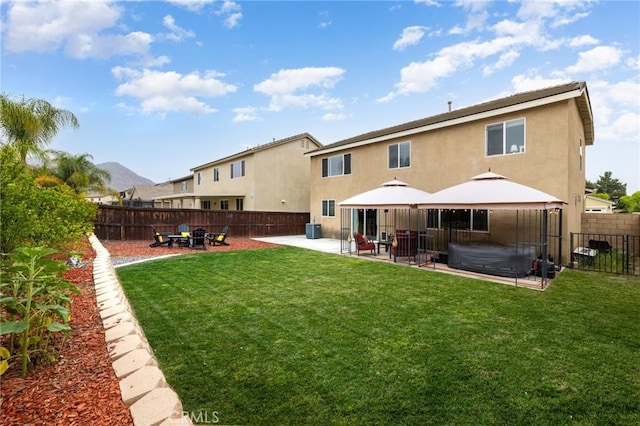 29304 Riptide Dr, Menifee, CA 92585 - rear view of property featuring a covered hot tub, stucco siding, a gazebo, and a patio area