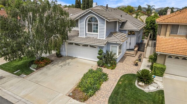 14252 Parkside Ct, Chino Hills, CA 91709 - view of front of house with a tiled roof, driveway, stucco siding, and an attached garage