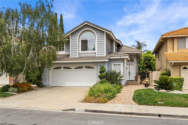 14252 Parkside Ct, Chino Hills, CA 91709 - traditional-style home with a garage, driveway, a tile roof, and stucco siding